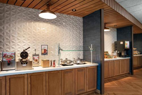 a kitchen with wooden cabinets and a counter top at Fairfield by Marriott Inn & Suites Lewisburg in Lewisburg
