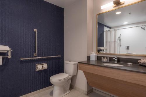 a bathroom with a toilet and a sink and a mirror at Fairfield by Marriott Inn & Suites Revelstoke in Revelstoke