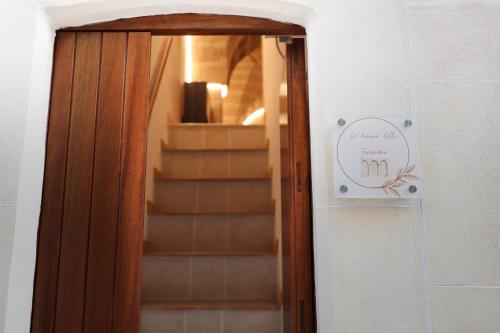 a door with a sign in front of a staircase at La dimora delle teresiane in Fasano