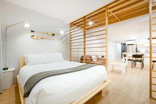 a bedroom with a white bed and a dining room at Les Lofts Charest - Par Les Lofts Vieux-Québec in Quebec City