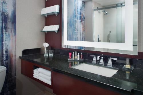 a bathroom with a sink and a mirror at Atlanta Airport Marriott Gateway in Atlanta
