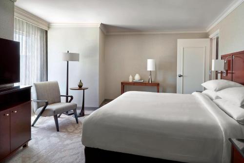 a hotel room with a large bed and a television at Atlanta Airport Marriott Gateway in Atlanta