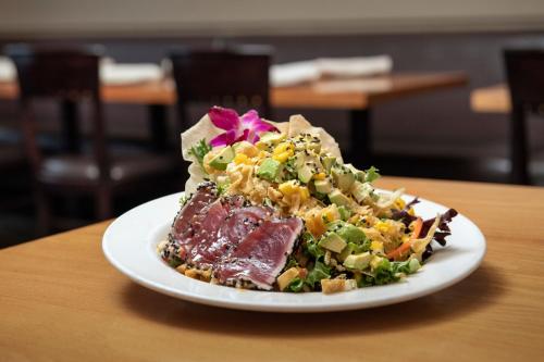 a plate of food with a salad on a table at The Westin Sacramento Riverfront Hotel & Spa in Sacramento
