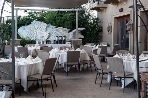a restaurant with white tables and chairs on a patio at The Westin Sacramento Riverfront Hotel & Spa in Sacramento