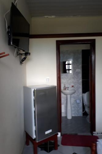 a bathroom with a television and a sink at Wikungo Hotel in Puerto Nariño