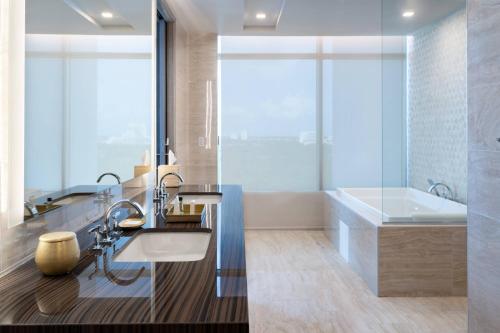 uma casa de banho com uma banheira, um lavatório e uma banheira tubermottermott em JW Marriott Orlando Bonnet Creek Resort & Spa em Orlando