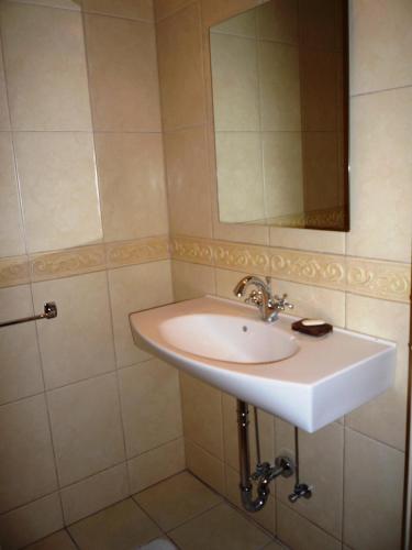a bathroom with a sink and a mirror at Home Sweet Home in Rīga