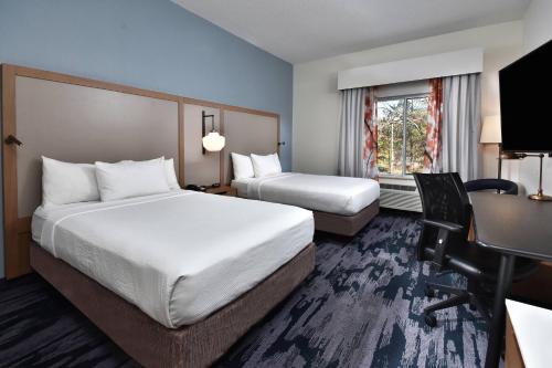 a hotel room with two beds and a desk at Fairfield Inn & Suites by Marriott Richmond Innsbrook in Richmond