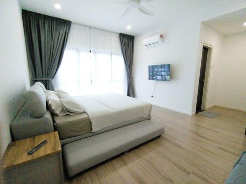 a bedroom with a bed and a couch and a window at H+M Residence [5min]to Setia City Convention in Shah Alam