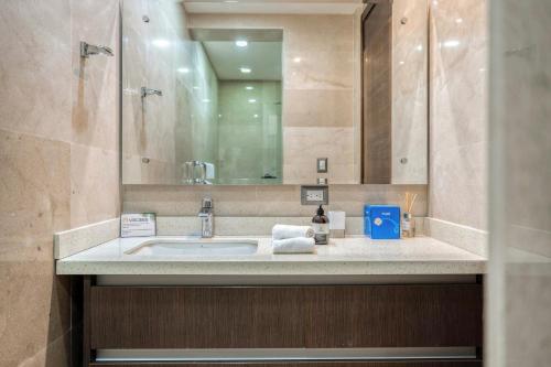a bathroom with a sink and a mirror at Altos de Montserrat 2 1 in Herradura