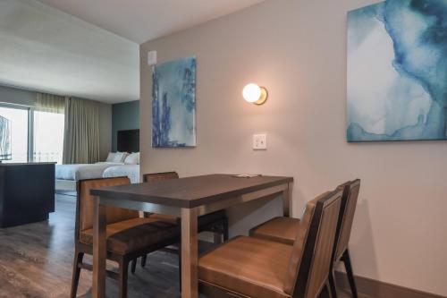 a living room with a dining room table and chairs at Residence Inn by Marriott Myrtle Beach Oceanfront in Myrtle Beach