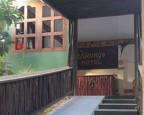 a building with a sign that reads village hotel at Wikungo Hotel in Puerto Nariño