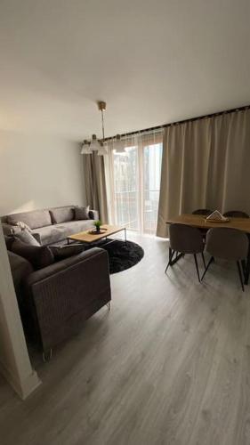 a living room with a couch and a table at Stunning Modern 2bed Apt Near Dublin City& Airport in Dublin