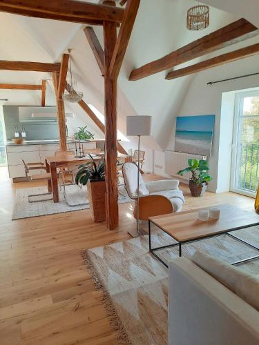 a living room with a couch and a table at Luxuriöses Loft mit schönem Blick in Tremsbüttel