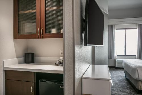 a small room with a bed and a kitchen at SpringHill Suites by Marriott Cheyenne in Cheyenne