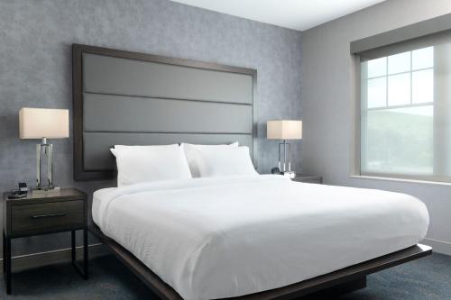 a bedroom with a large white bed and a window at Residence Inn by Marriott Orangeburg in Orangeburg