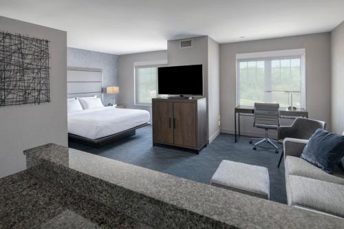 a hotel room with a bed and a television at Residence Inn by Marriott Orangeburg in Orangeburg