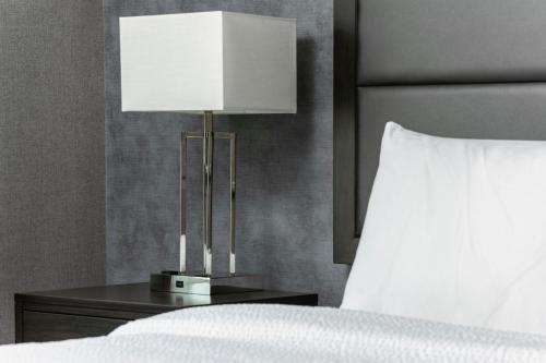 a lamp on a table next to a bed at Residence Inn by Marriott Orangeburg in Orangeburg