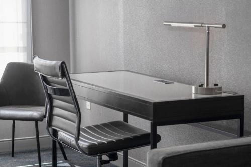 a black desk with a lamp and two chairs at Residence Inn by Marriott Orangeburg in Orangeburg