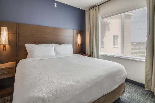 a large bed in a hotel room with a window at Residence Inn by Marriott Dallas DFW Airport West/Bedford in Bedford