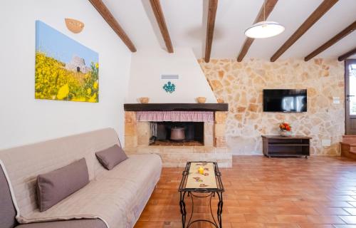 a living room with a couch and a fireplace at Villa Mariant con Piscina Privata in Ruffano