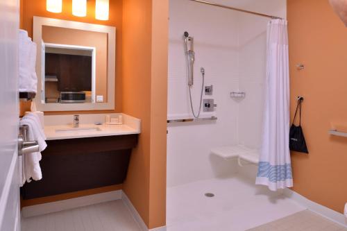 a bathroom with a shower and a sink and a toilet at TownePlace Suites by Marriott St. Louis Chesterfield in Chesterfield