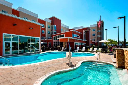 a swimming pool in front of a hotel at Residence Inn by Marriott New York Long Island East End in Riverhead