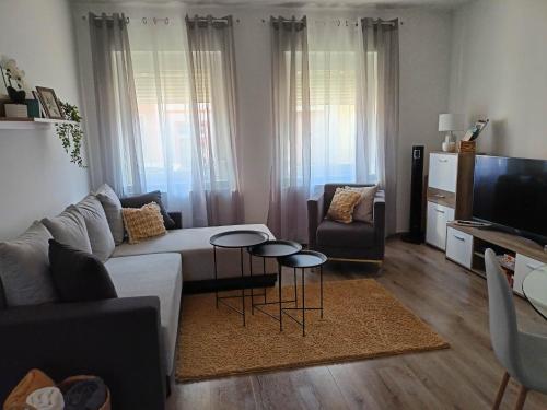 a living room with a couch and a table at Centrum Apartman Kőszeg in Kőszeg