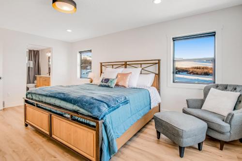 a bedroom with a bed and a chair and a window at The Belle of Bear Lake in Fish Haven