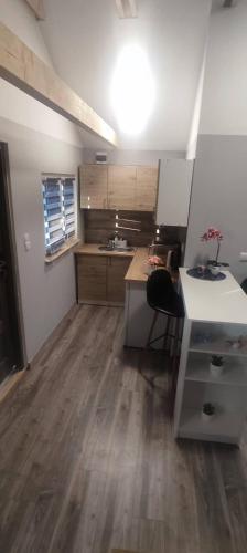 a kitchen with a table and a desk in a room at Bajkowe Domki Marzeń Krecik in Węgorzewo