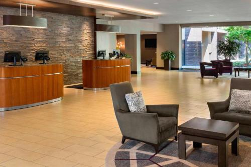 a lobby of a hospital with chairs and a table at Sheraton Vancouver Airport Hotel in Richmond