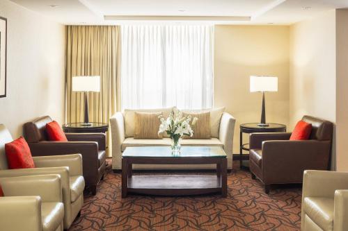 a hotel room with a couch and chairs and a table at Sheraton Vancouver Airport Hotel in Richmond