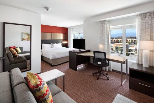 a hotel room with a bed and a desk with a computer at Residence Inn by Marriott San Jose Cupertino in Cupertino