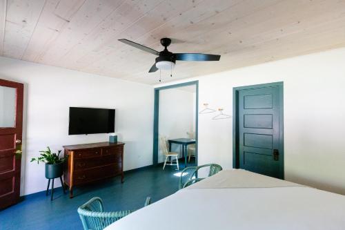 a bedroom with a bed and a ceiling fan at Piety Hill Cottages in Nevada City