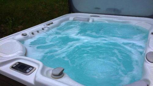 a bath tub with blue water in it at Romantisches Plätzchen in der Natur in Grindelwald
