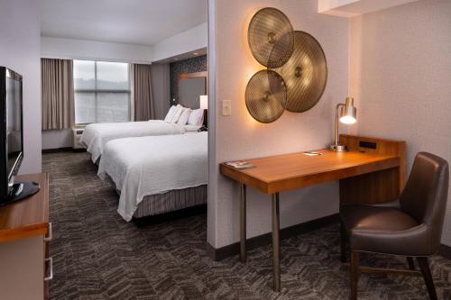 a hotel room with two beds and a desk at SpringHill Suites by Marriott Pittsburgh North Shore in Pittsburgh