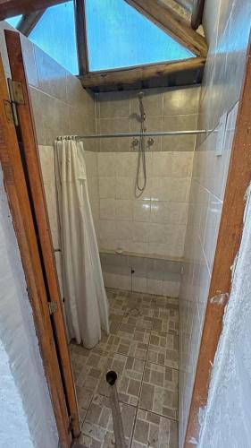 a bathroom with a shower and a shower curtain at Carpe Diem in Las Heras