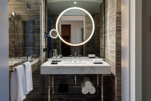 a bathroom with a sink and a mirror at The Tasman, a Luxury Collection Hotel, Hobart in Hobart