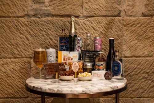 a table with a bunch of bottles of wine and snacks at The Tasman, a Luxury Collection Hotel, Hobart in Hobart