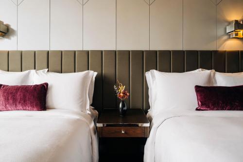 two beds sitting next to each other in a hotel room at The Tasman, a Luxury Collection Hotel, Hobart in Hobart
