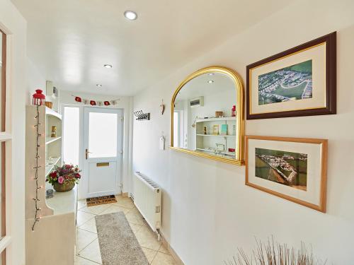 a hallway with two mirrors on the wall at Springfields Bungalow in Exeter