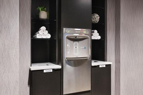 a food machine in a kitchen with two shelves at Courtyard by Marriott Burlington in Burlington