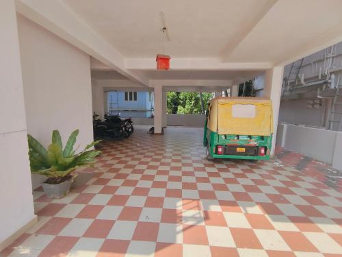 a room with a van parked on a checkered floor at Retaj Residency in Ernakulam