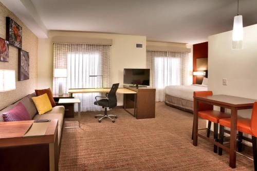 a hotel room with a bed and a living room at Residence Inn by Marriott Casper in Casper