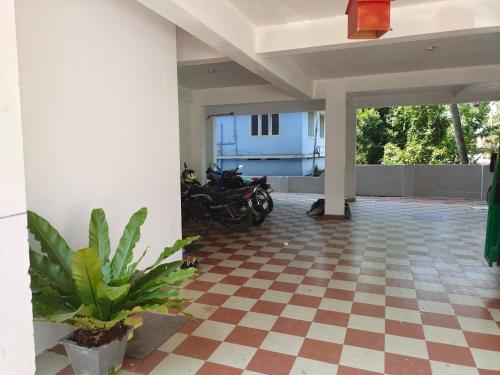 a patio with motorcycles parked on a checkered floor at Retaj Residency in Ernakulam