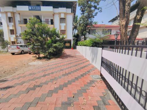 a brick sidewalk in front of a building at Retaj Residency in Ernakulam