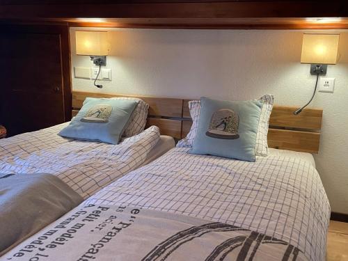 two beds sitting next to each other in a room at Penthouse - Ski-in Ski-out 30 meters from Medran lift and 40 meters from W Hotel in Verbier