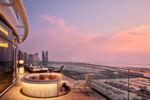 a balcony with a tub and chairs on a building at W Dubai - Mina Seyahi in Dubai