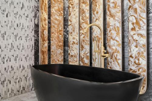 a black tub in a bathroom with a wall at W Dubai - Mina Seyahi in Dubai