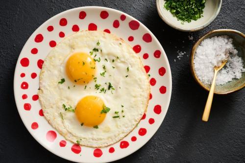 two eggs in a bowl on a plate on a table at W Dubai - Mina Seyahi in Dubai